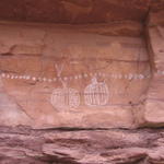 white dotted rock art on top of very very old faint archaic red anthropomorphs