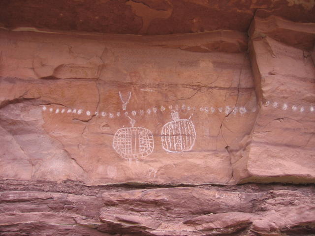 white dotted rock art on top of very very old faint archaic red anthropomorphs